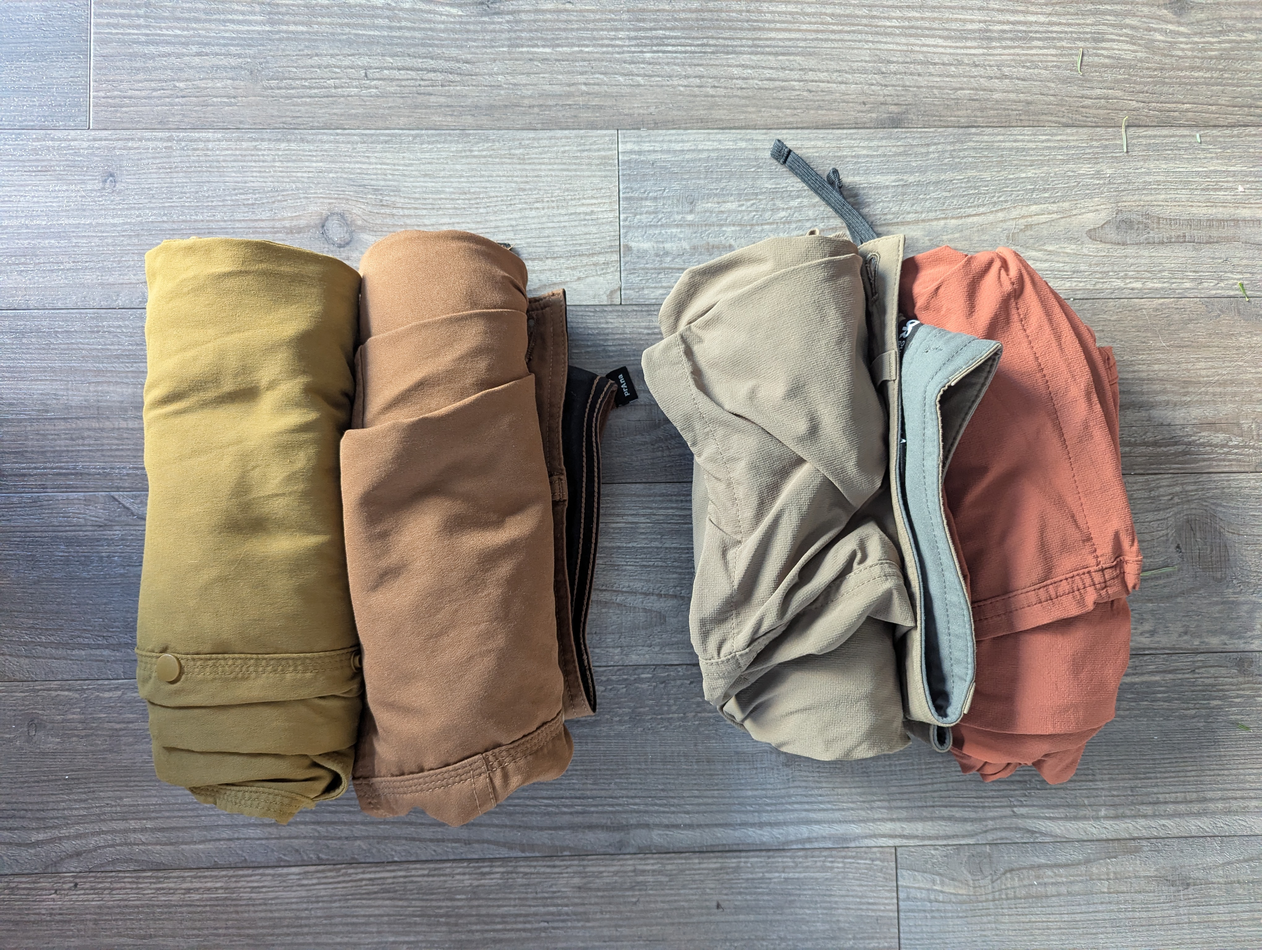 A picture of four pairs of pants rolled up.
